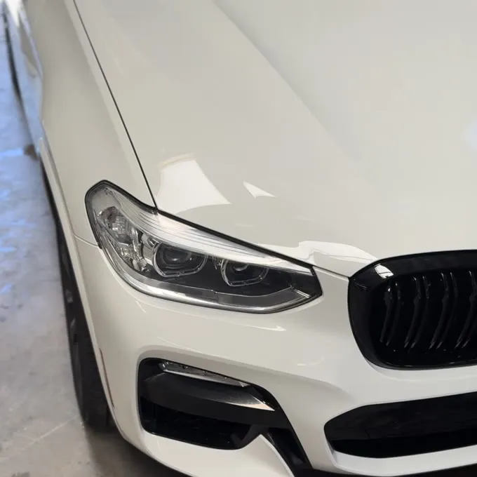 White BMW X3 front end gleaming after a detail