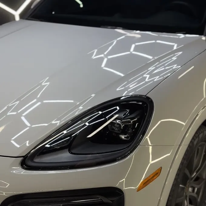 Porsche Cayenne front end after paint detailing under studio lights