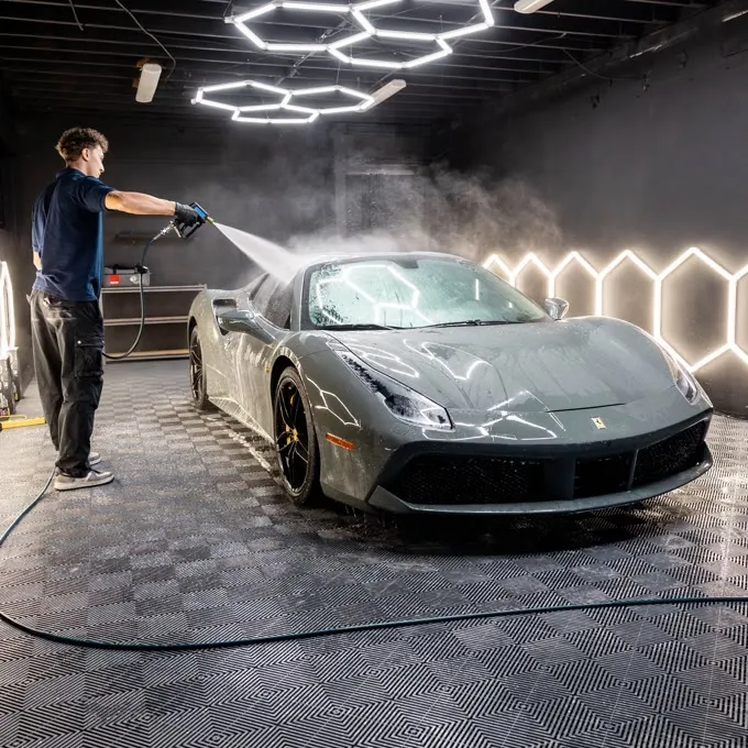 Rinsing a Ferrari 488 during a full detail in the Severin Detailing bay